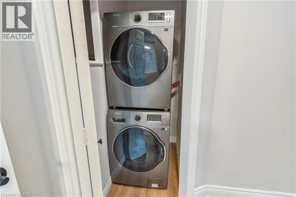 A washer and dryer stacked on top of each other in a small laundry room.