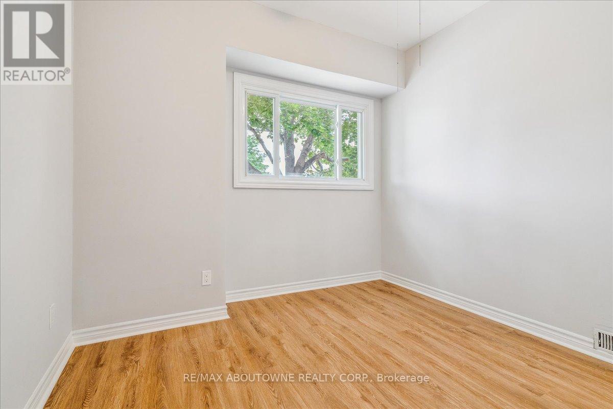 A room with a window showing trees outside.