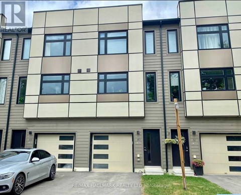 A modern building with a car parked in front.