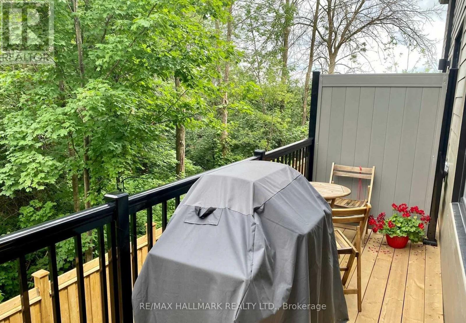 A grey umbrella is on a wooden deck.