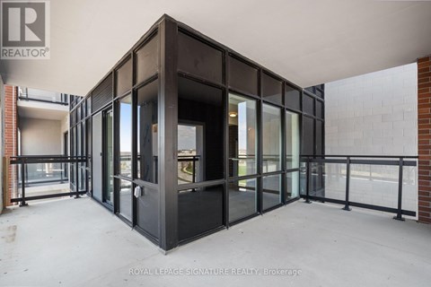 A large, empty room with a glass door and windows.