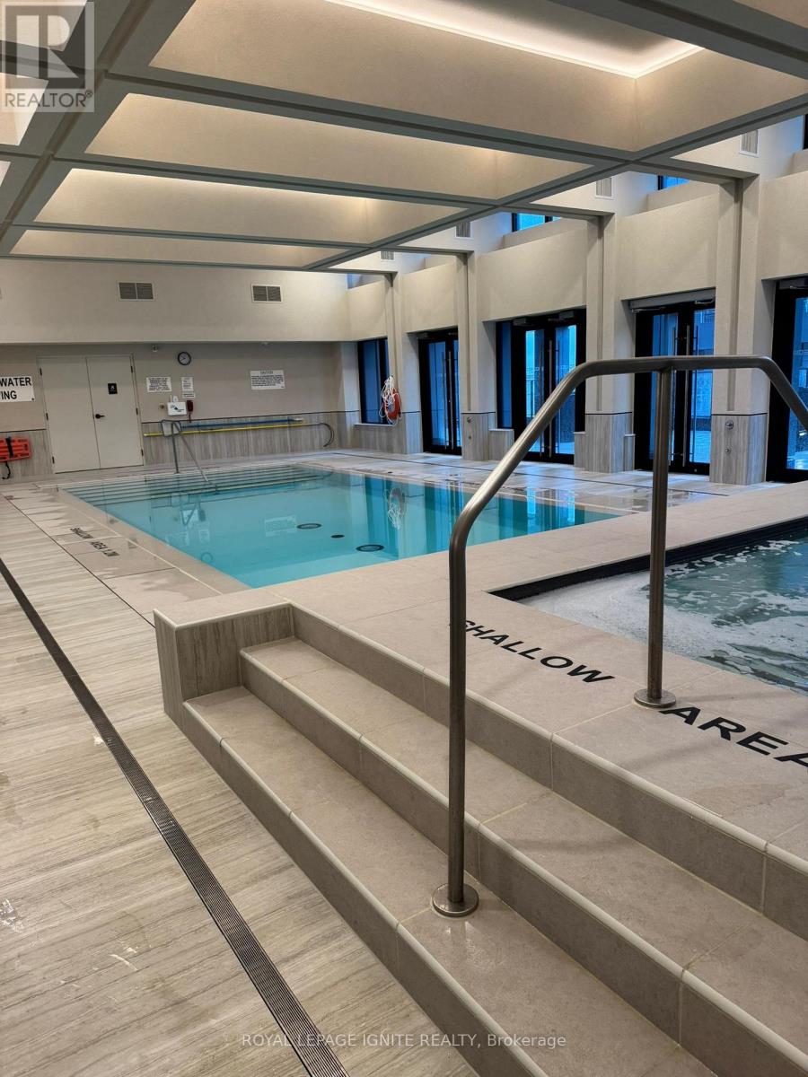A swimming pool with a slide in a large room.