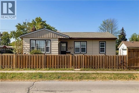 A house with a brown fence in front of it.