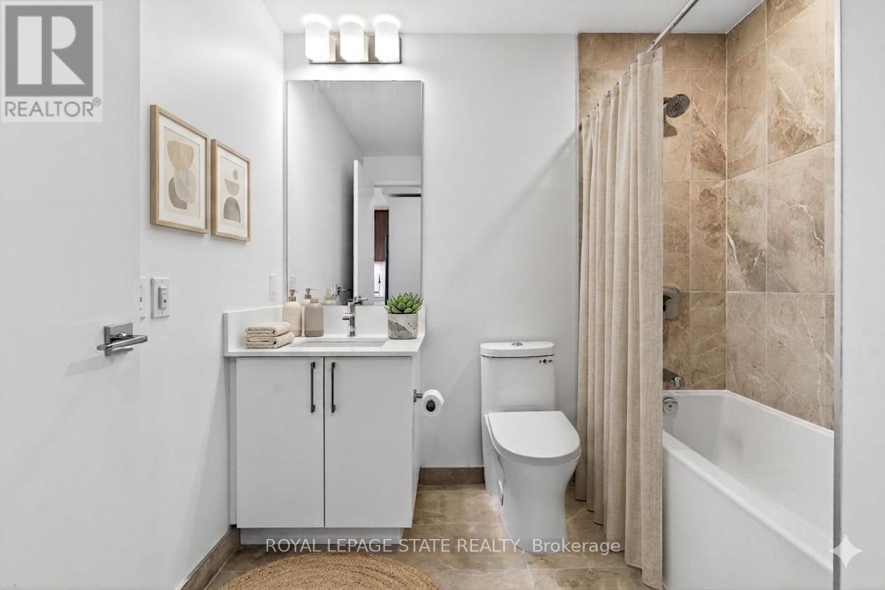 A bathroom with a toilet, sink, and bathtub.