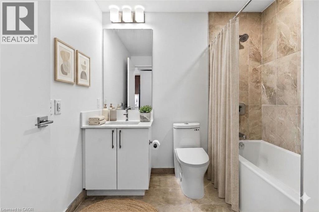 A bathroom with a toilet, sink, and bathtub.