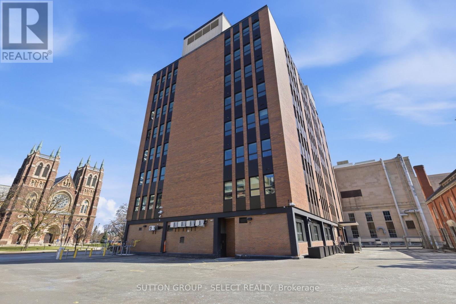 A tall building with a glass facade is the main focus of the image.