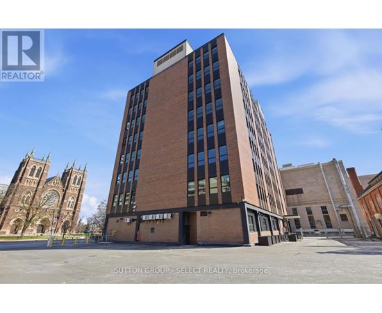 A tall building with a glass facade is the main focus of the image.