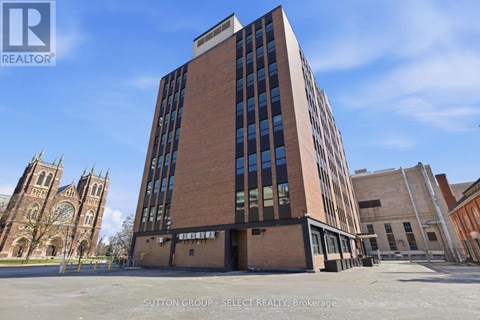 A tall building with a glass facade is the main focus of the image.