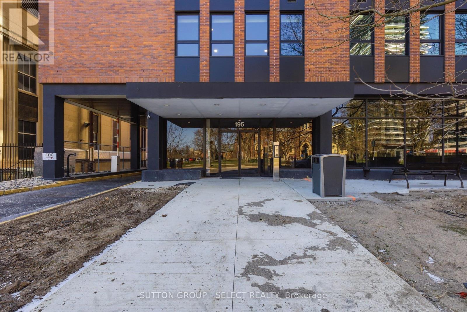 A modern building with a brick facade and a large glass entrance.