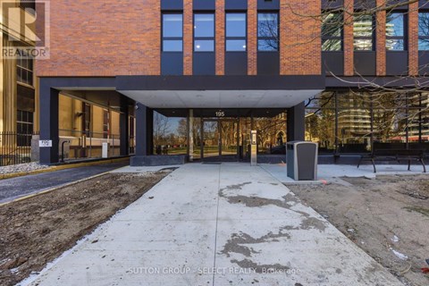 A modern building with a brick facade and a large glass entrance.