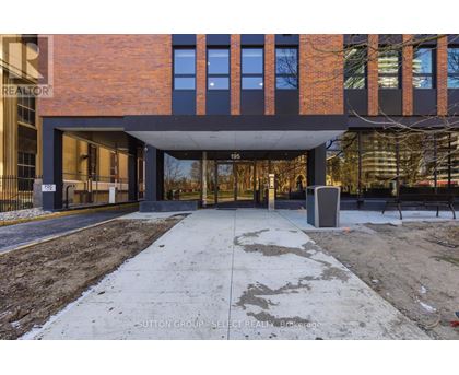 A modern building with a brick facade and a large glass entrance.