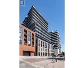 A modern multi-story building with a glass facade is under construction.