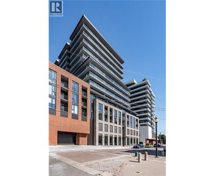 A modern multi-story building with a glass facade is under construction.