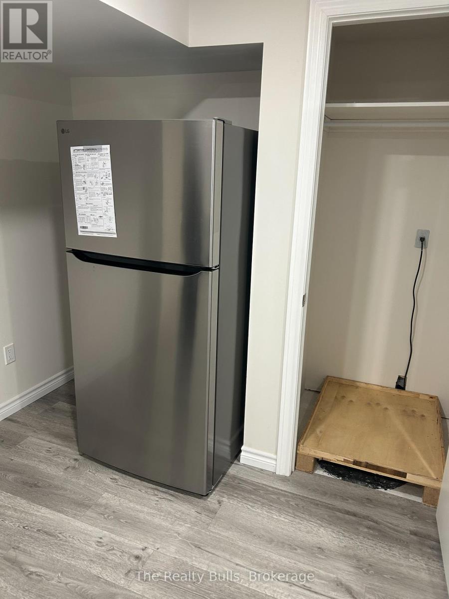 A stainless steel refrigerator with a paper on it.
