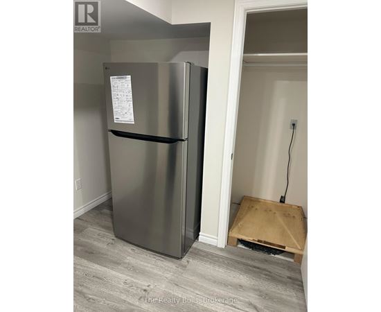 A stainless steel refrigerator with a paper on it.
