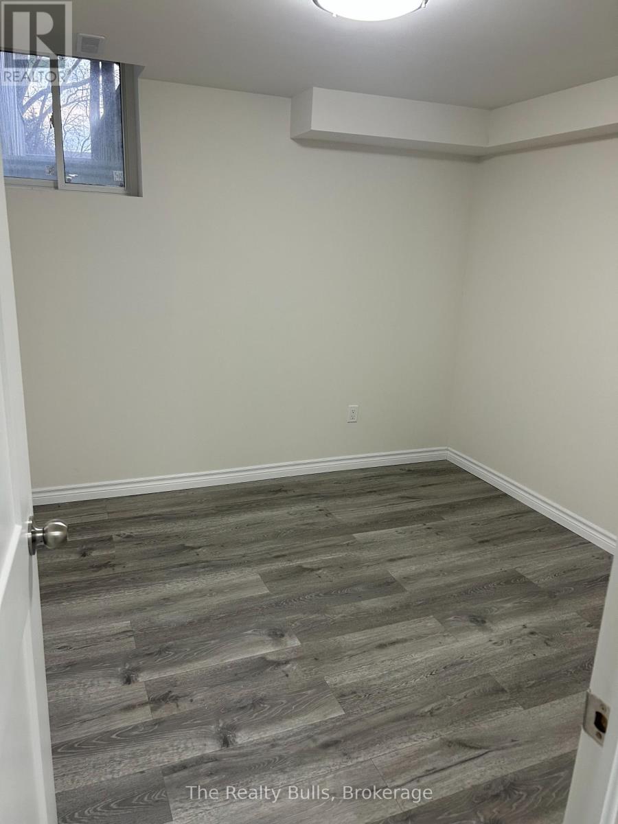 A room with a wooden floor and a window.