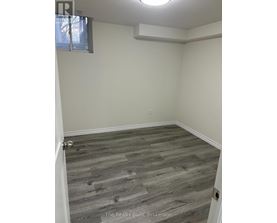 A room with a wooden floor and a window.