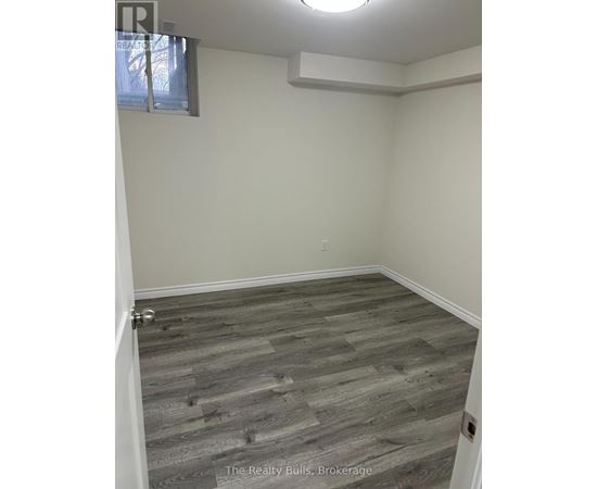 A room with a wooden floor and a window.