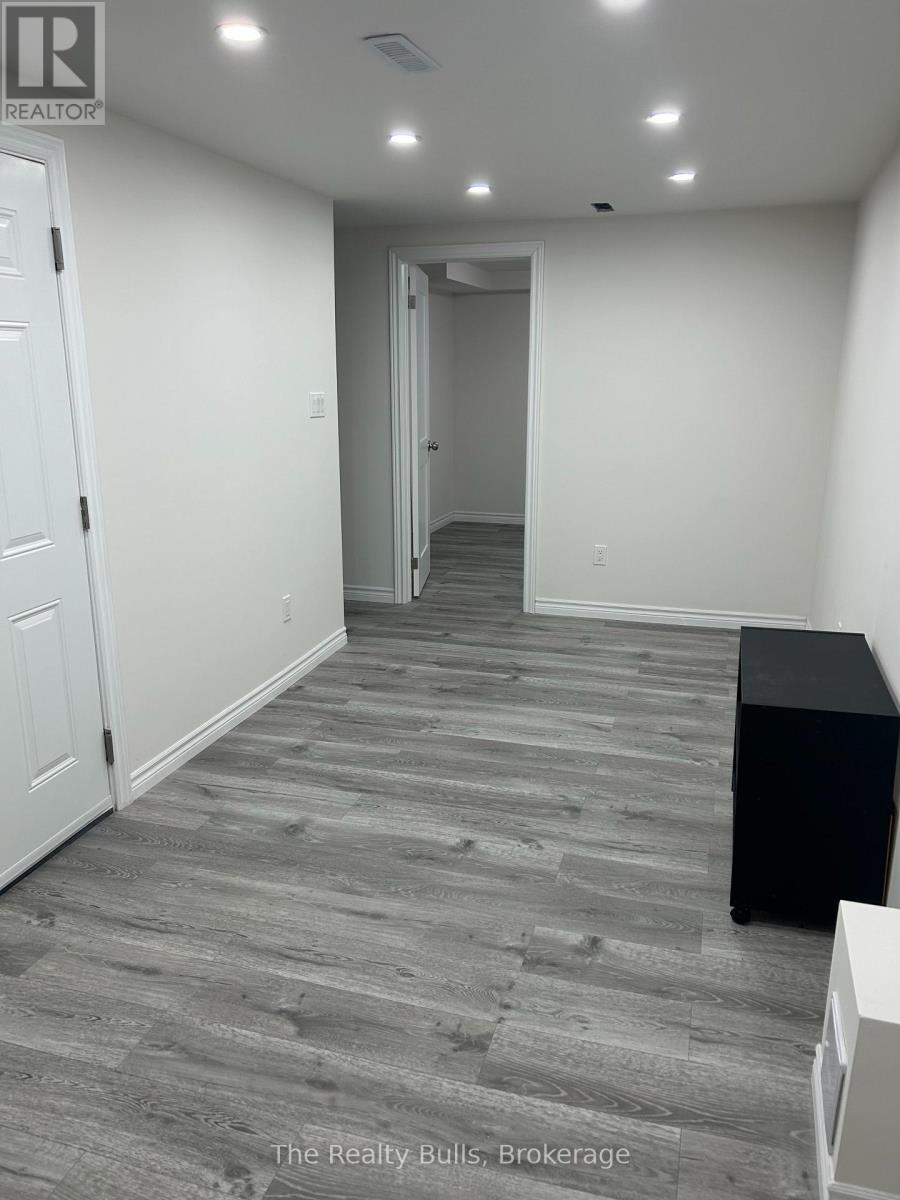 A hallway with a black box on the floor and a white door on the left.