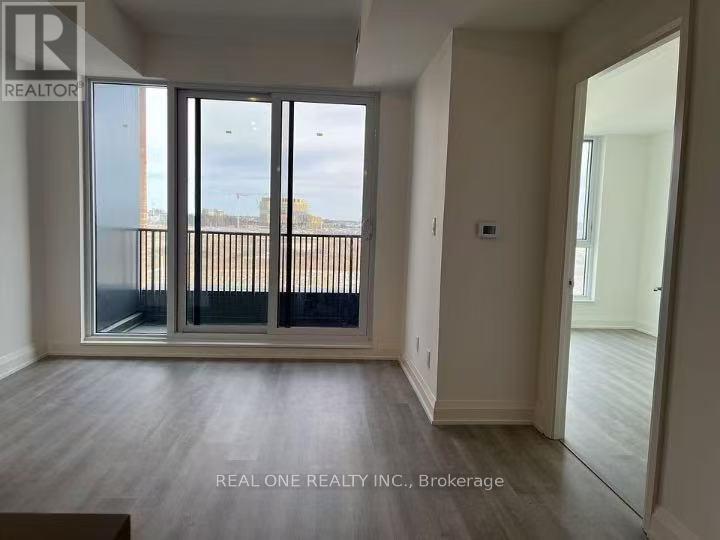 A room with a sliding glass door leading to a balcony.