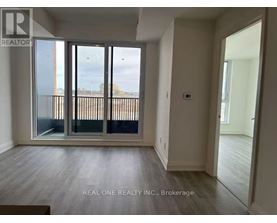 A room with a sliding glass door leading to a balcony.