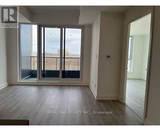 A room with a sliding glass door leading to a balcony.