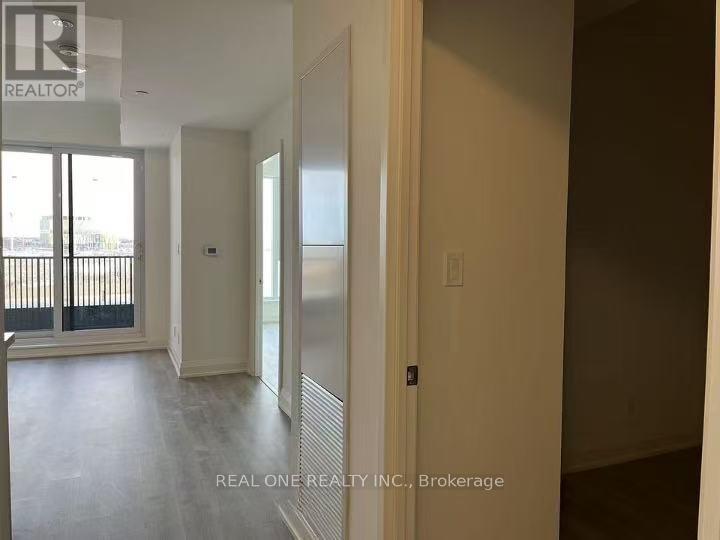 A room with a sliding glass door and a wall with a window.