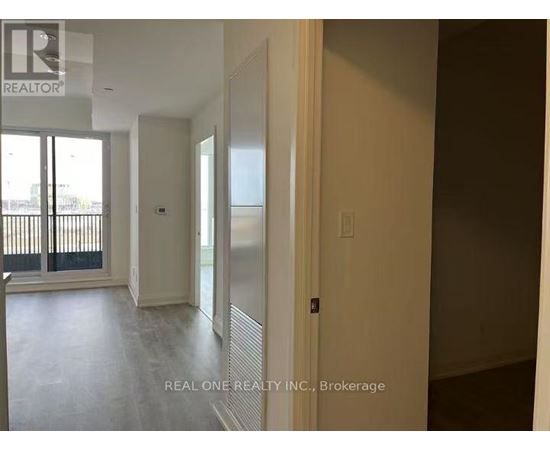 A room with a sliding glass door and a wall with a window.