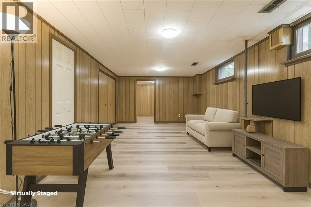 A virtual staged living room with a foosball table and a couch.