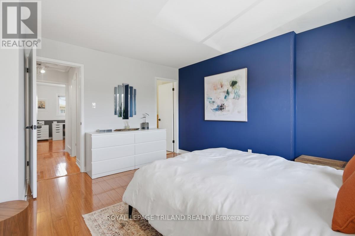 A bedroom with a white bed and a blue wall.