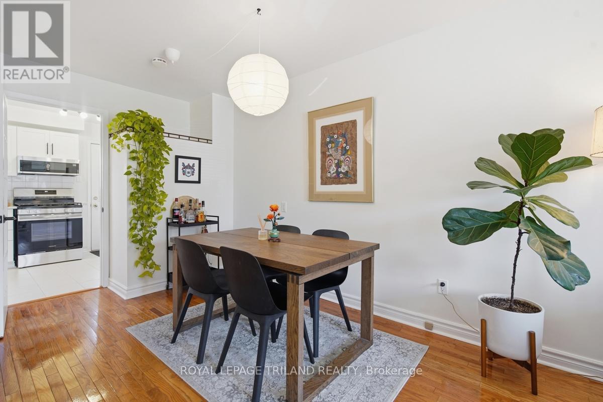 A dining room with a wooden table and chairs.