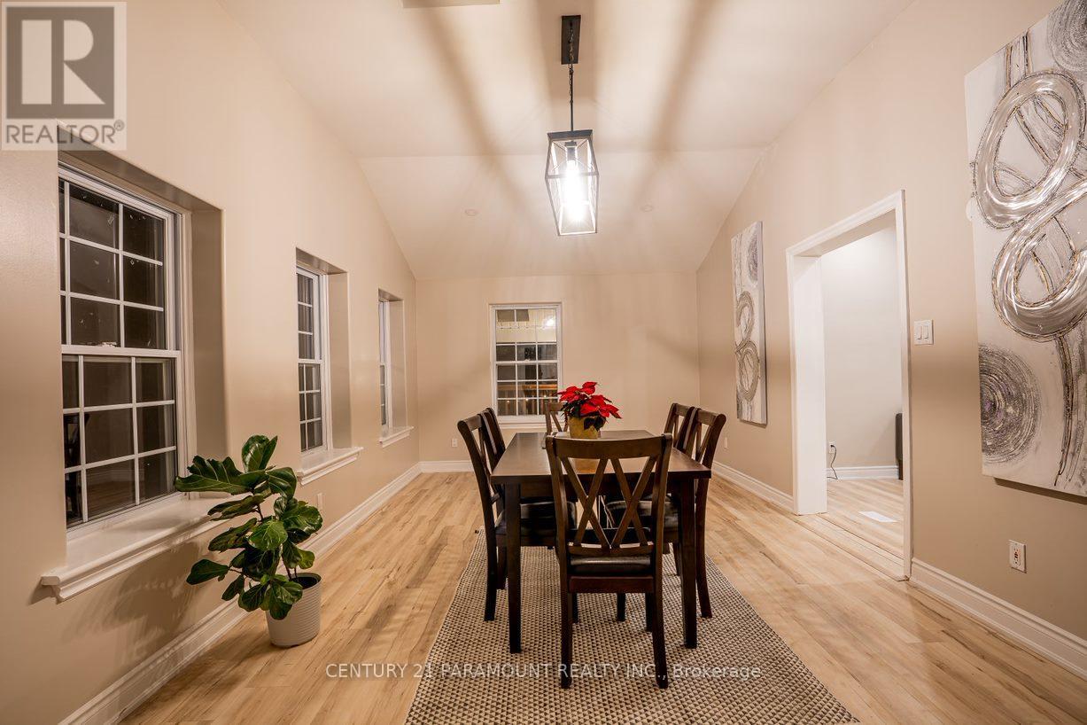A dining room with a wooden table and chairs.