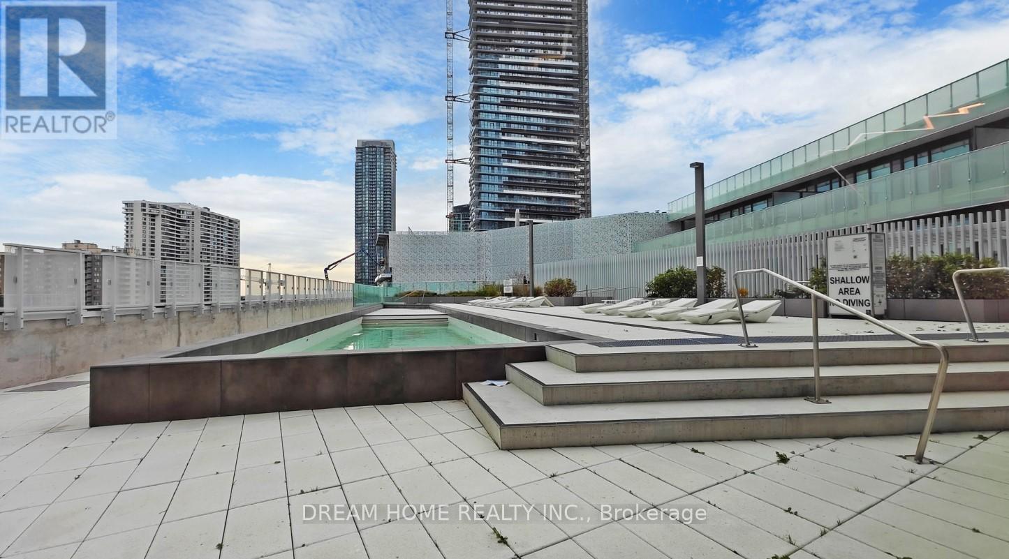 A rooftop terrace with a pool and a view of the city.