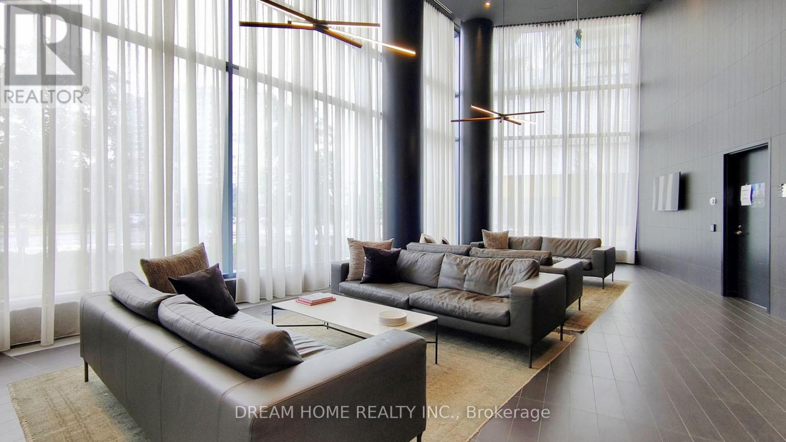 A modern living room with a large sectional sofa and a coffee table.