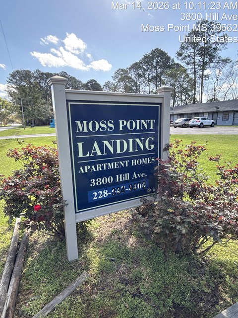 A blue and white sign for Moss Point Landing Apartment Homes.