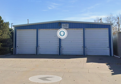 A blue garage door with a white sign on it.