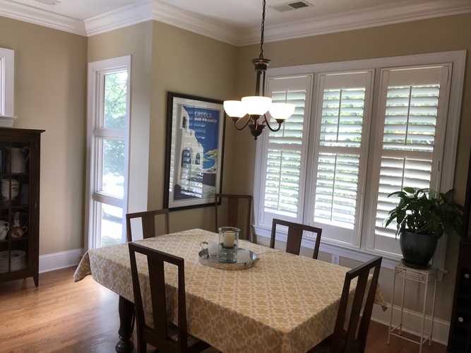 A dining room with a table set for two.