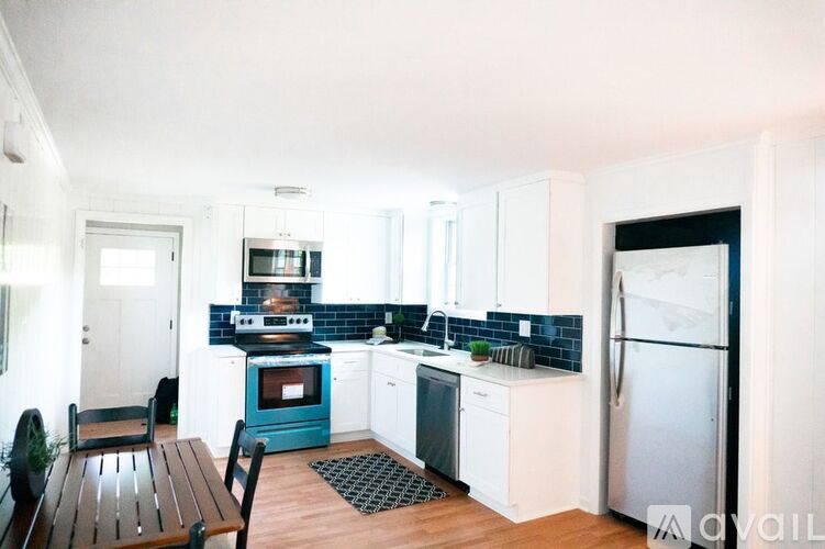 A kitchen with white cabinets and a blue oven.