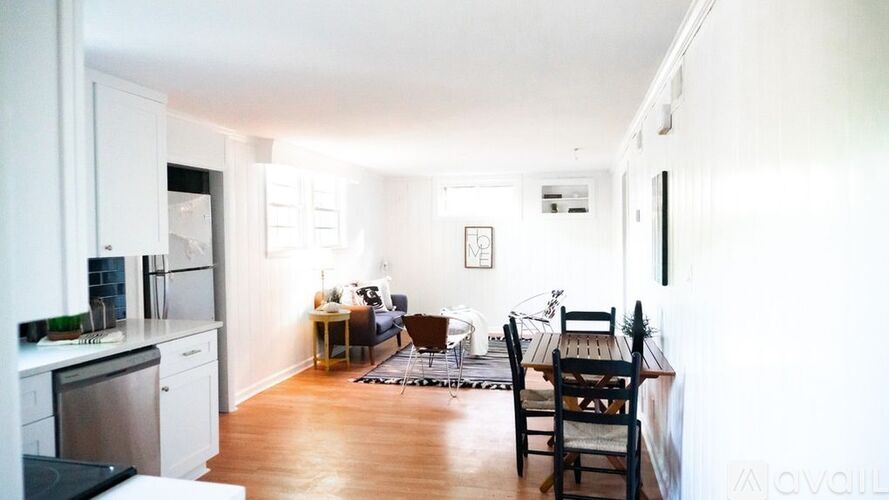 A kitchen with a dining table and chairs.