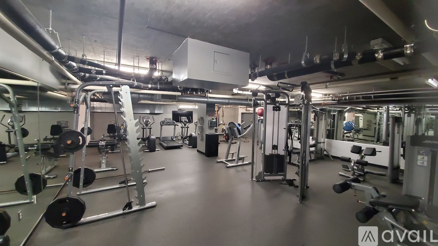 A gym with a variety of equipment including weights and machines.