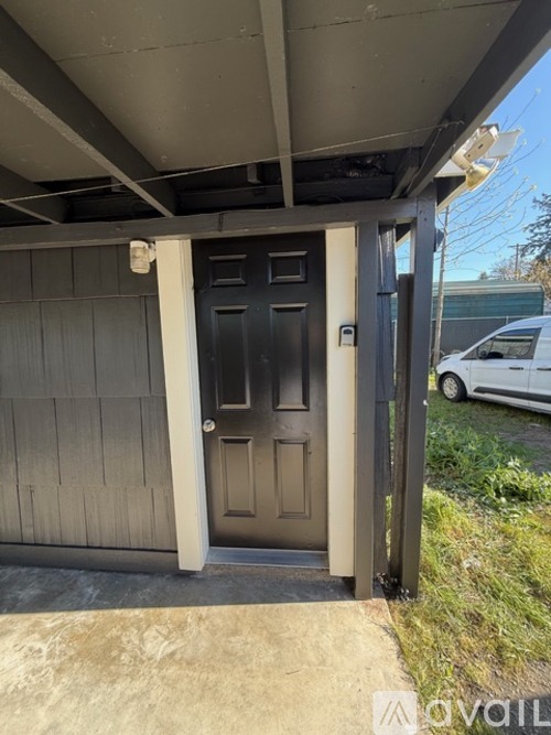 A black door is on the left side of a white door.