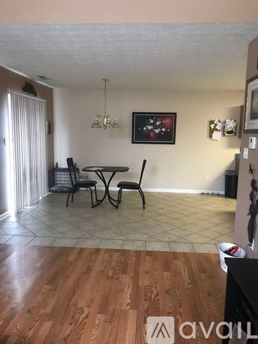 A dining room with a table and chairs.