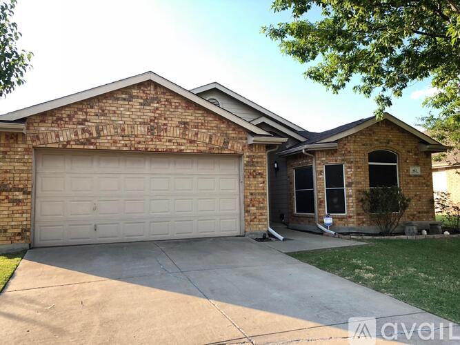A house with a garage door and a driveway.