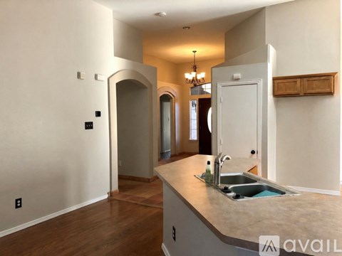A kitchen with a sink and a chandelier.