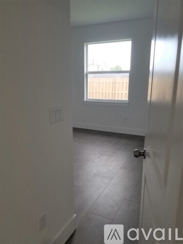 A room with a window and a door.