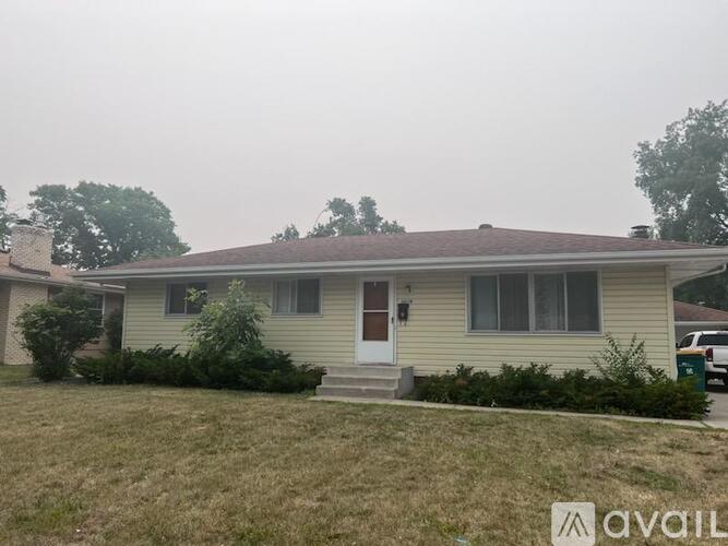 A house with a brown door and a small front yard.