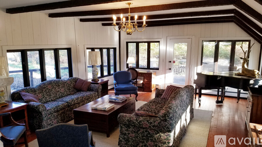 A living room with a piano and a couch.