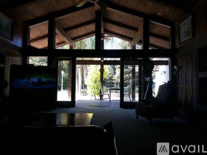 A dark living room with a television on.