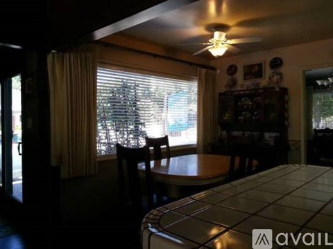 A dining room with a table and chairs.