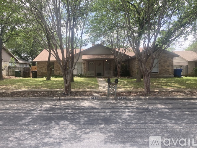 A house with a front yard and trees.